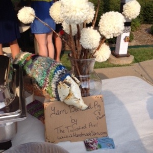 Yarn Bombed Pig and Pom Pom Flowers by The Twisted Purl