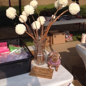 Yarn Bombed Pig and Pom Pom Flowers by The Twisted Purl