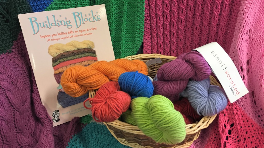 Knitter Building Blocks Series with yarn and finished blanket